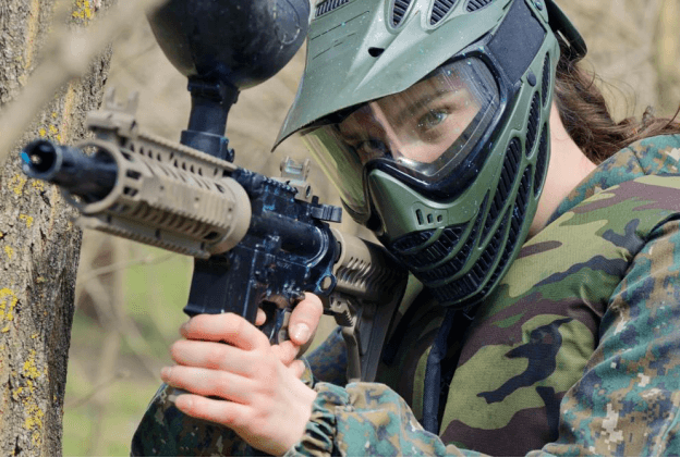 girl playing paintball with a camouflage suit